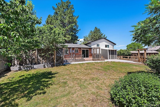 9350 Raleigh Ct, Westminster, CO 80031 - rear view of property with a patio area, a fenced backyard, brick siding, and a sunroom