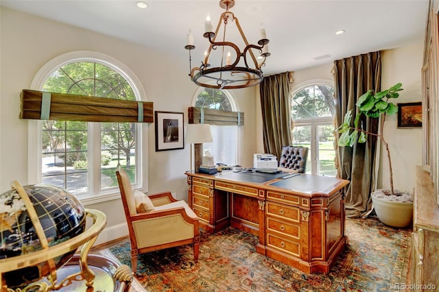 home office featuring a healthy amount of sunlight and an inviting chandelier