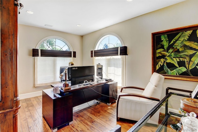 home office with hardwood / wood-style flooring