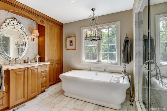 bathroom featuring tile patterned floors, vanity, a chandelier, and independent shower and bath