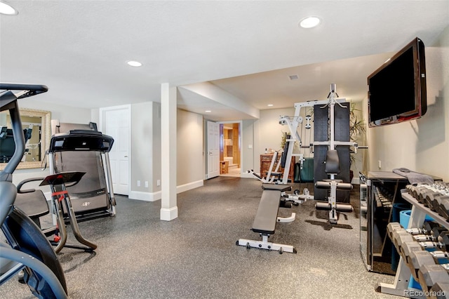 workout room with recessed lighting and baseboards