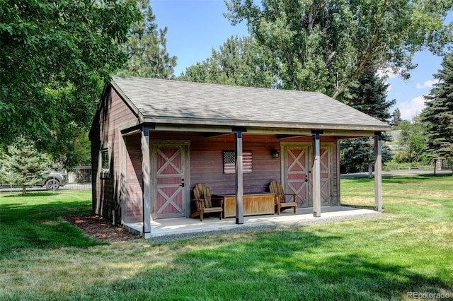 view of outbuilding with a yard