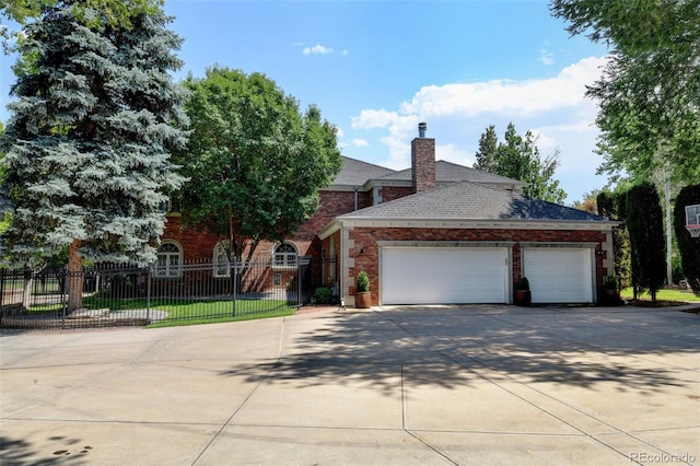 view of front of property featuring brick siding, a chimney, fence, a garage, and driveway