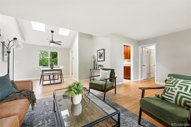 5436 E Atlantic Pl, Denver, CO 80222 - living area featuring a skylight, light wood finished floors, baseboards, vaulted ceiling, and ceiling fan