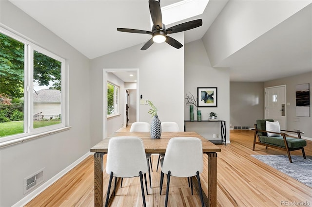 5436 E Atlantic Pl, Denver, CO 80222 - dining space with plenty of natural light, light wood-style flooring, vaulted ceiling, and baseboards