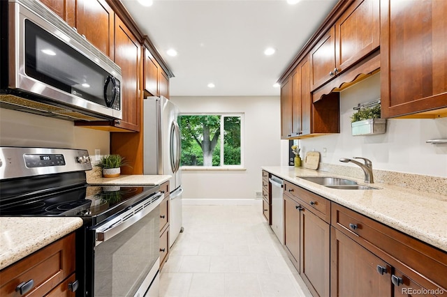 5436 E Atlantic Pl, Denver, CO 80222 - kitchen with stainless steel appliances, a sink, baseboards, light stone countertops, and recessed lighting