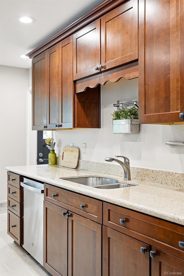 5436 E Atlantic Pl, Denver, CO 80222 - kitchen featuring a sink, stainless steel dishwasher, light stone counters, recessed lighting, and light tile patterned floors