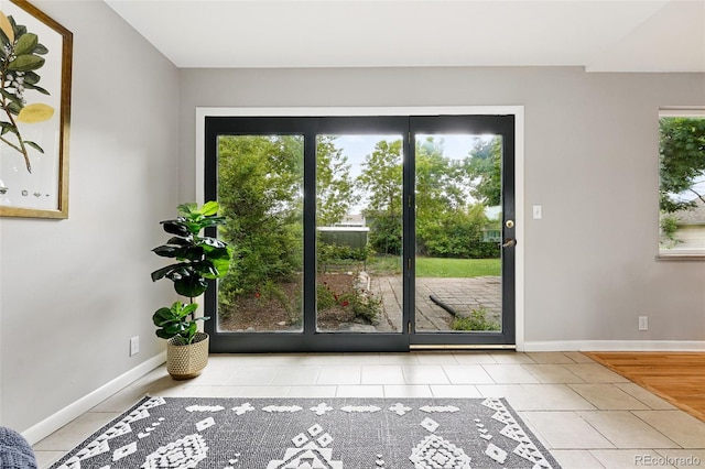 5436 E Atlantic Pl, Denver, CO 80222 - doorway to outside featuring tile patterned floors and baseboards