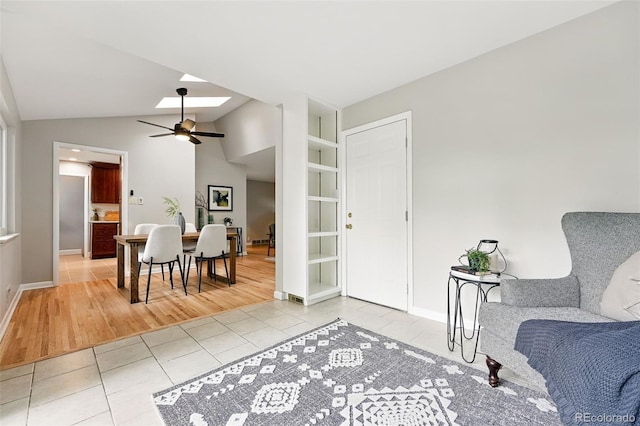 5436 E Atlantic Pl, Denver, CO 80222 - entryway with light tile patterned floors, ceiling fan, a skylight, baseboards, and lofted ceiling