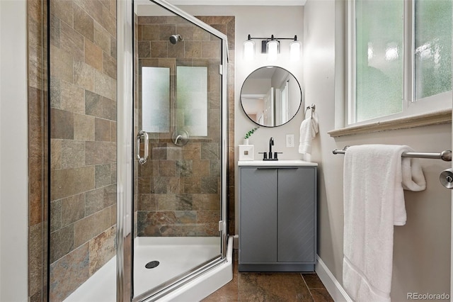 5436 E Atlantic Pl, Denver, CO 80222 - bathroom featuring a stall shower, vanity, and baseboards
