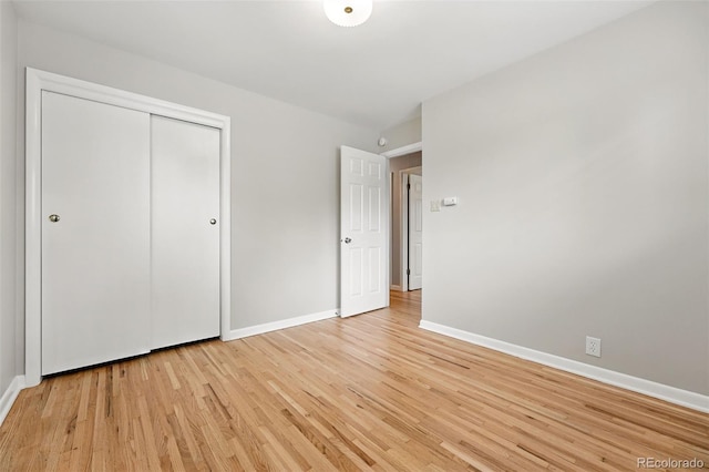 5436 E Atlantic Pl, Denver, CO 80222 - unfurnished bedroom with light wood-type flooring, baseboards, and a closet