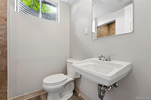 5436 E Atlantic Pl, Denver, CO 80222 - half bathroom with toilet, wood finished floors, and baseboards