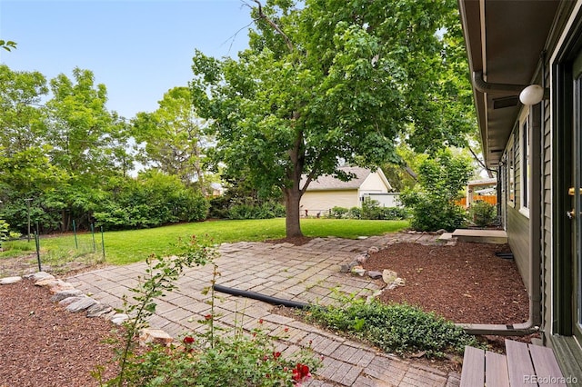5436 E Atlantic Pl, Denver, CO 80222 - view of grassy yard featuring a patio