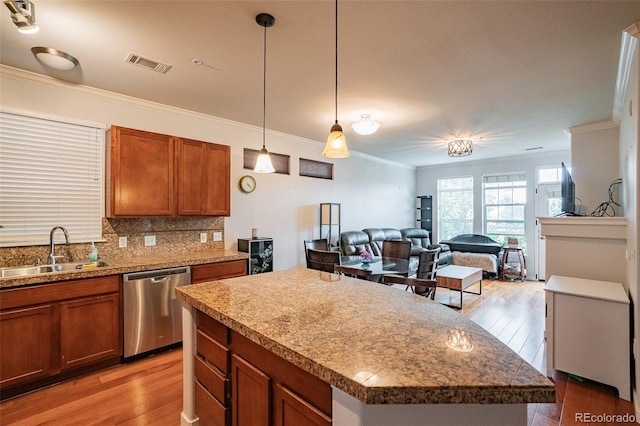 13456 Via Varra Unit 225, Broomfield, CO 80020 - kitchen featuring dishwasher, crown molding, brown cabinetry, light wood-type flooring, and decorative backsplash