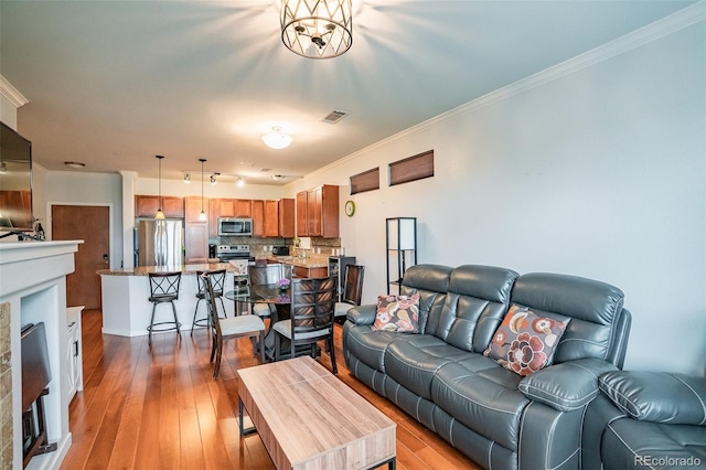 13456 Via Varra Unit 225, Broomfield, CO 80020 - living area featuring crown molding and wood-type flooring