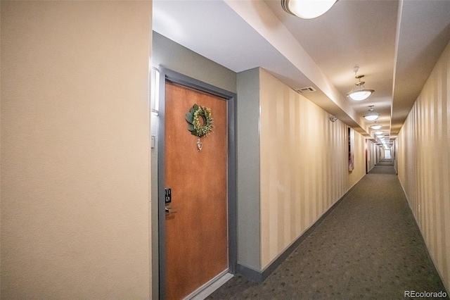 13456 Via Varra Unit 225, Broomfield, CO 80020 - corridor with baseboards and dark carpet