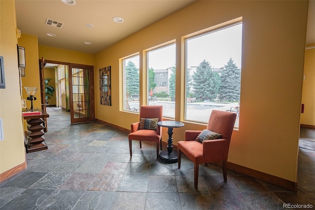 13456 Via Varra Unit 225, Broomfield, CO 80020 - sitting room with stone tile floors and recessed lighting