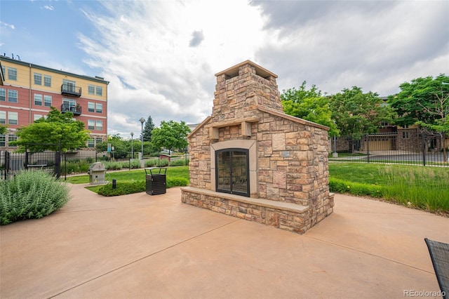 13456 Via Varra Unit 225, Broomfield, CO 80020 - view of patio with an outdoor stone fireplace
