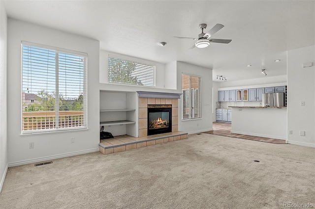 750 Capeglen Rd, Colorado Springs, CO 80906 - unfurnished living room with carpet, a ceiling fan, baseboards, a tiled fireplace, and recessed lighting