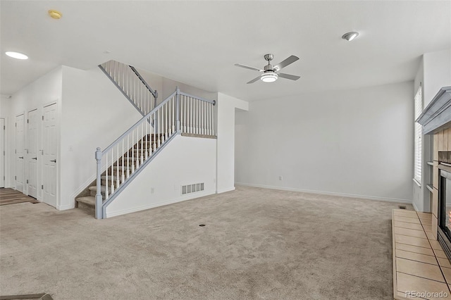 750 Capeglen Rd, Colorado Springs, CO 80906 - unfurnished living room with a fireplace, carpet floors, stairs, a ceiling fan, and baseboards