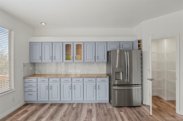 750 Capeglen Rd, Colorado Springs, CO 80906 - kitchen featuring stainless steel refrigerator with ice dispenser, healthy amount of natural light, light wood-type flooring, and gray cabinetry