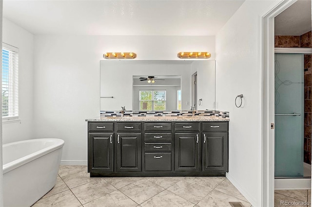 750 Capeglen Rd, Colorado Springs, CO 80906 - bathroom with a ceiling fan, a stall shower, double vanity, a freestanding bath, and baseboards