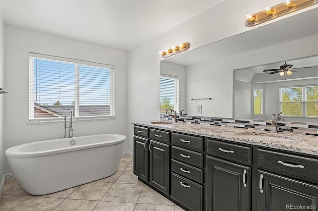 750 Capeglen Rd, Colorado Springs, CO 80906 - full bathroom featuring double vanity, ceiling fan, a soaking tub, and decorative backsplash