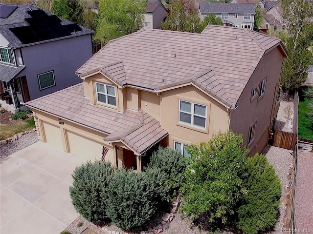 750 Capeglen Rd, Colorado Springs, CO 80906 - view of front facade with stucco siding, driveway, an attached garage, and a tile roof