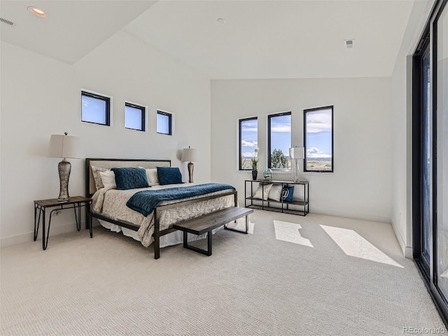 carpeted bedroom featuring lofted ceiling