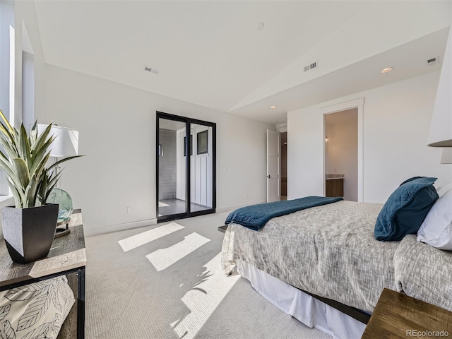 carpeted bedroom featuring ensuite bath, access to exterior, and lofted ceiling