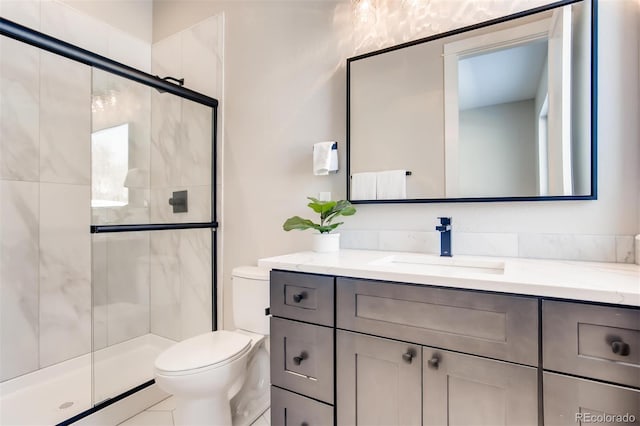 bathroom featuring a shower with shower door, vanity, toilet, and tile flooring