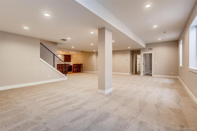 basement featuring light carpet