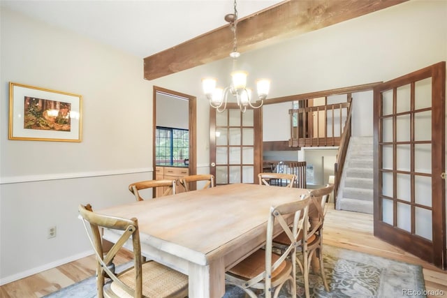 510 Silhouette Way, Monument, CO 80132 - dining space with beam ceiling, a chandelier, wood finished floors, and stairs