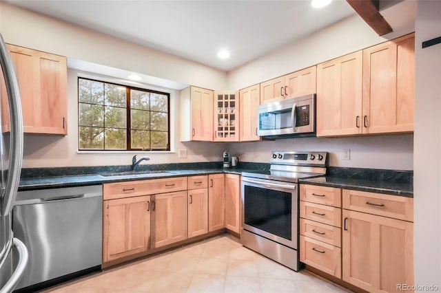 510 Silhouette Way, Monument, CO 80132 - kitchen with appliances with stainless steel finishes, light brown cabinets, recessed lighting, light tile patterned floors, and glass insert cabinets