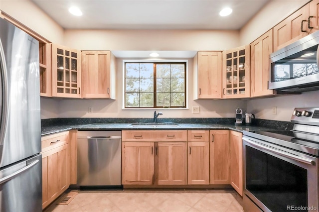510 Silhouette Way, Monument, CO 80132 - kitchen with stainless steel appliances, light brown cabinetry, glass insert cabinets, recessed lighting, and dark stone counters