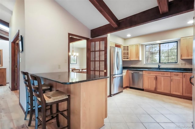 510 Silhouette Way, Monument, CO 80132 - kitchen featuring appliances with stainless steel finishes, a breakfast bar, glass insert cabinets, recessed lighting, and light brown cabinets