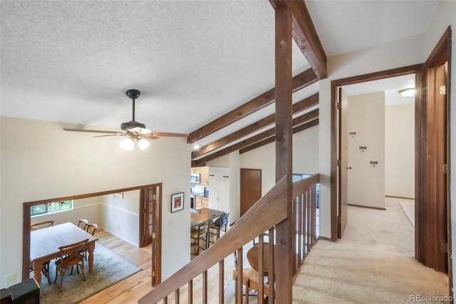 510 Silhouette Way, Monument, CO 80132 - hallway featuring an upstairs landing and a textured ceiling
