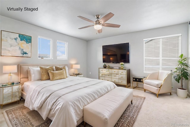 bedroom featuring ceiling fan and carpet