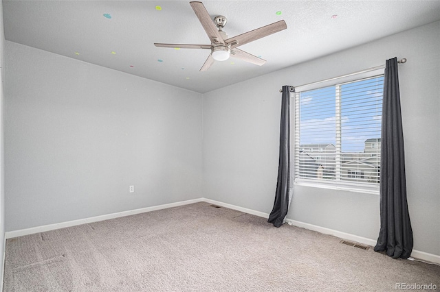 carpeted empty room featuring ceiling fan