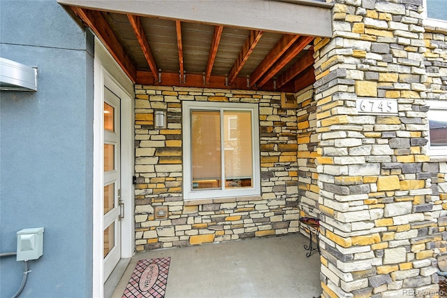 6745 S Tempe Ct, Aurora, CO 80016 - doorway to property with stone siding
