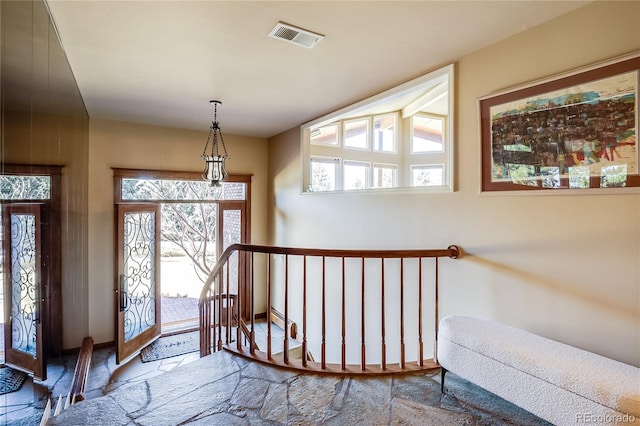 entrance foyer with visible vents and baseboard heating