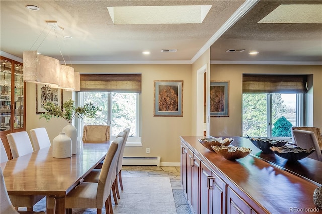 dining area with a baseboard heating unit, plenty of natural light, a textured ceiling, and crown molding