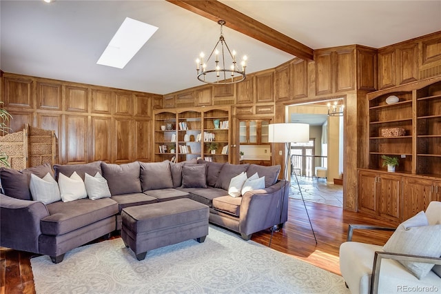 living area featuring wooden walls, built in features, and a chandelier