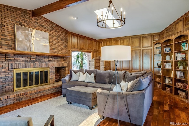 living area featuring brick wall, vaulted ceiling with beams, a fireplace, a notable chandelier, and dark wood-style flooring