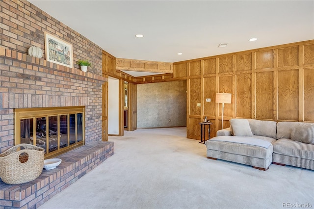 carpeted living area with recessed lighting and a fireplace