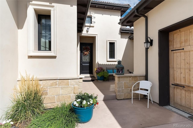 entrance to property featuring a patio