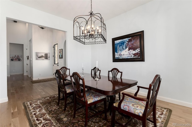 dining space with an inviting chandelier and hardwood / wood-style flooring