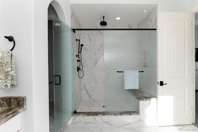 bathroom featuring vanity and a shower with shower door