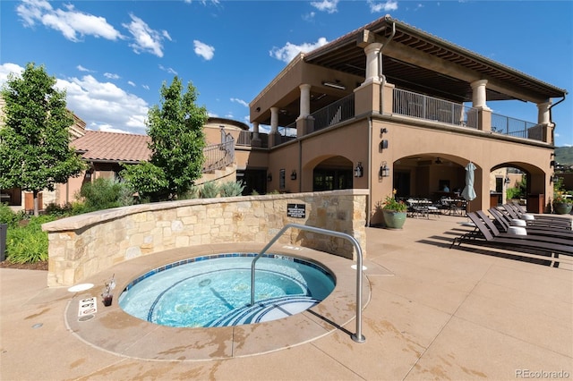 view of swimming pool with a community hot tub and a patio