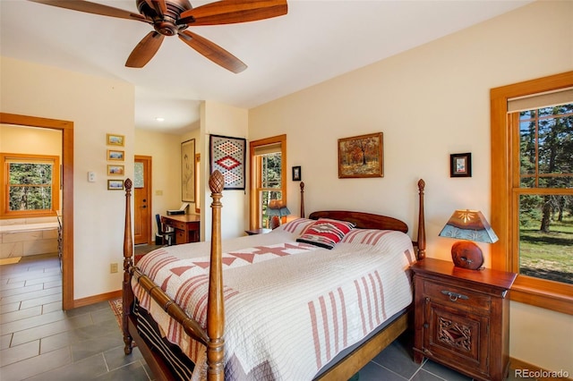 tiled bedroom featuring ceiling fan, connected bathroom, and multiple windows